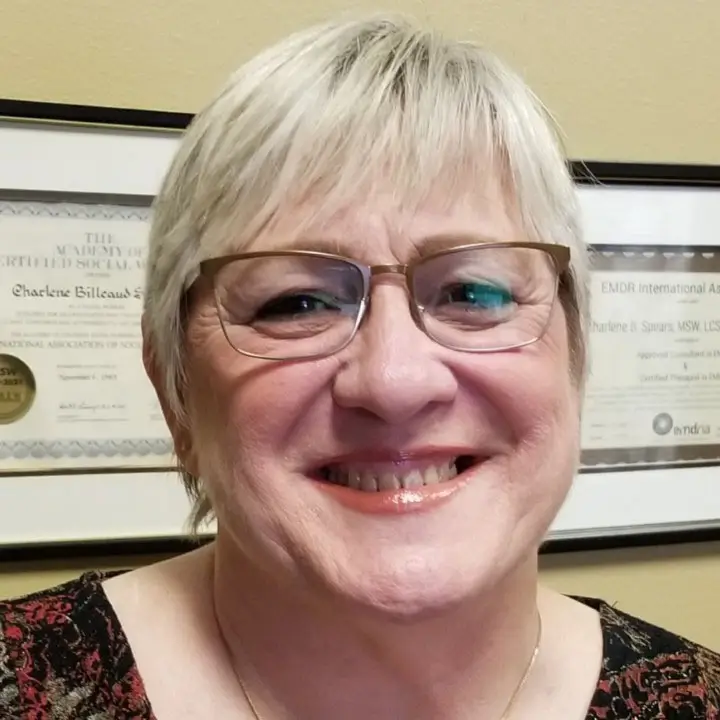 Charlene Spears, LCSW smiling with EMDRIA certificates | Certified EMDR Therapist & Consultant | Abita Springs, LA (70420)