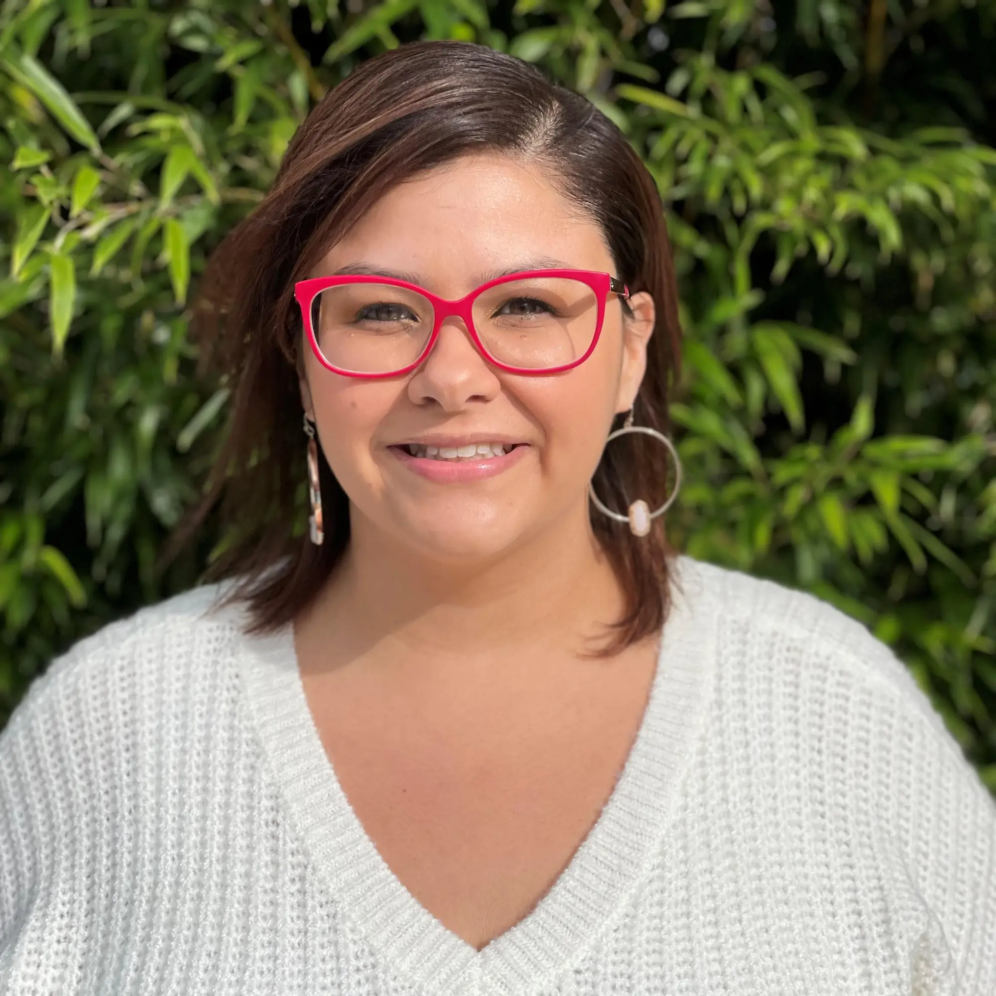 Christina Watts-Figueroa smiling in red glasses | Bilingual Mental Health Support | Slidell, LA (70458)
